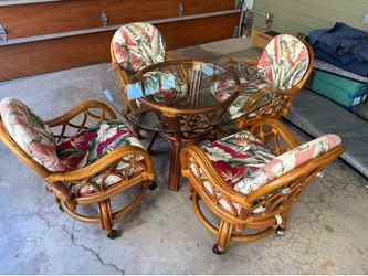 Mid century rattan  kitchen /dining room table and chairs, chairs are swivel with casters 42 in glass top good shape