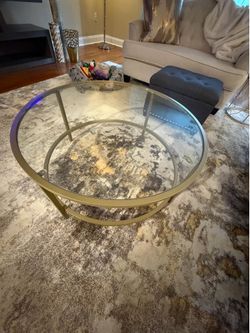 Large round gold metal and glass living room table. Available for pick up first weekend in June.