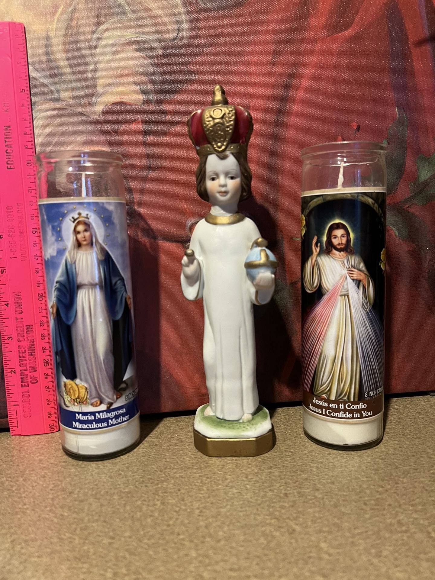 Infant Of Prague Statue And Religious Candles