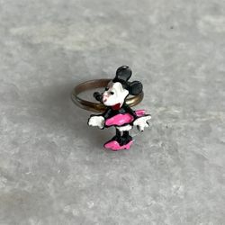 The Vintage Walt Disney Production Minnie Mouse Adjustable Ring is a charming piece of Disney collectible jewelry featuring the beloved character Minn