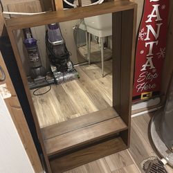Mirror with a shelf