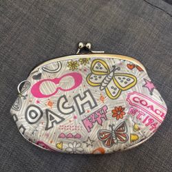 Vintage Coach Poppy butterfly and graffiti print kisslock pouch featuring a playful mix of colorful graphics and silver-tone hardware.