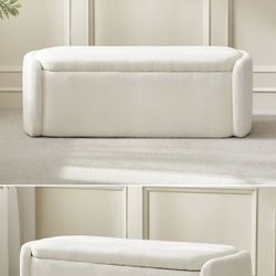 Cream chenille upholstered bench with storage space.