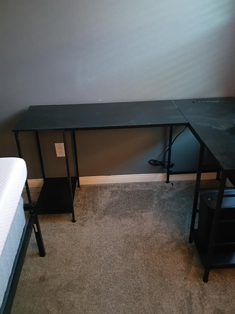 black laminate computer table with inserted plugins