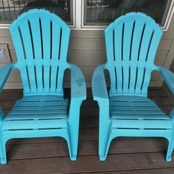Two teal Adirondack chairs