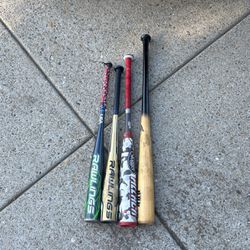 Four Baseball Bats three metal and one wooden