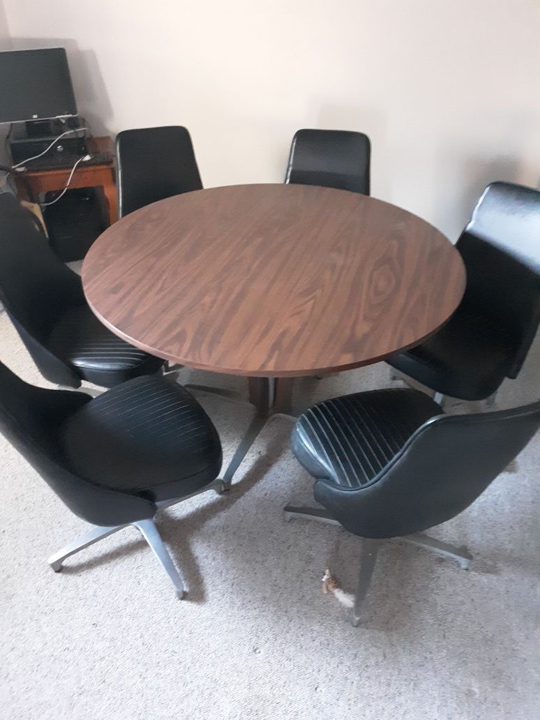 Brown wooden round table with six chairs