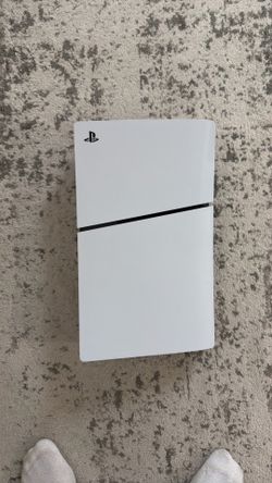 PlayStation five with two black controllers