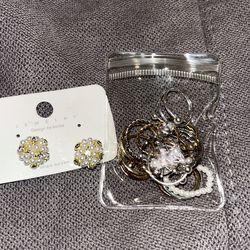 Pearl earrings + many rings