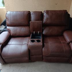 Reclining leather sofa with phone charger
