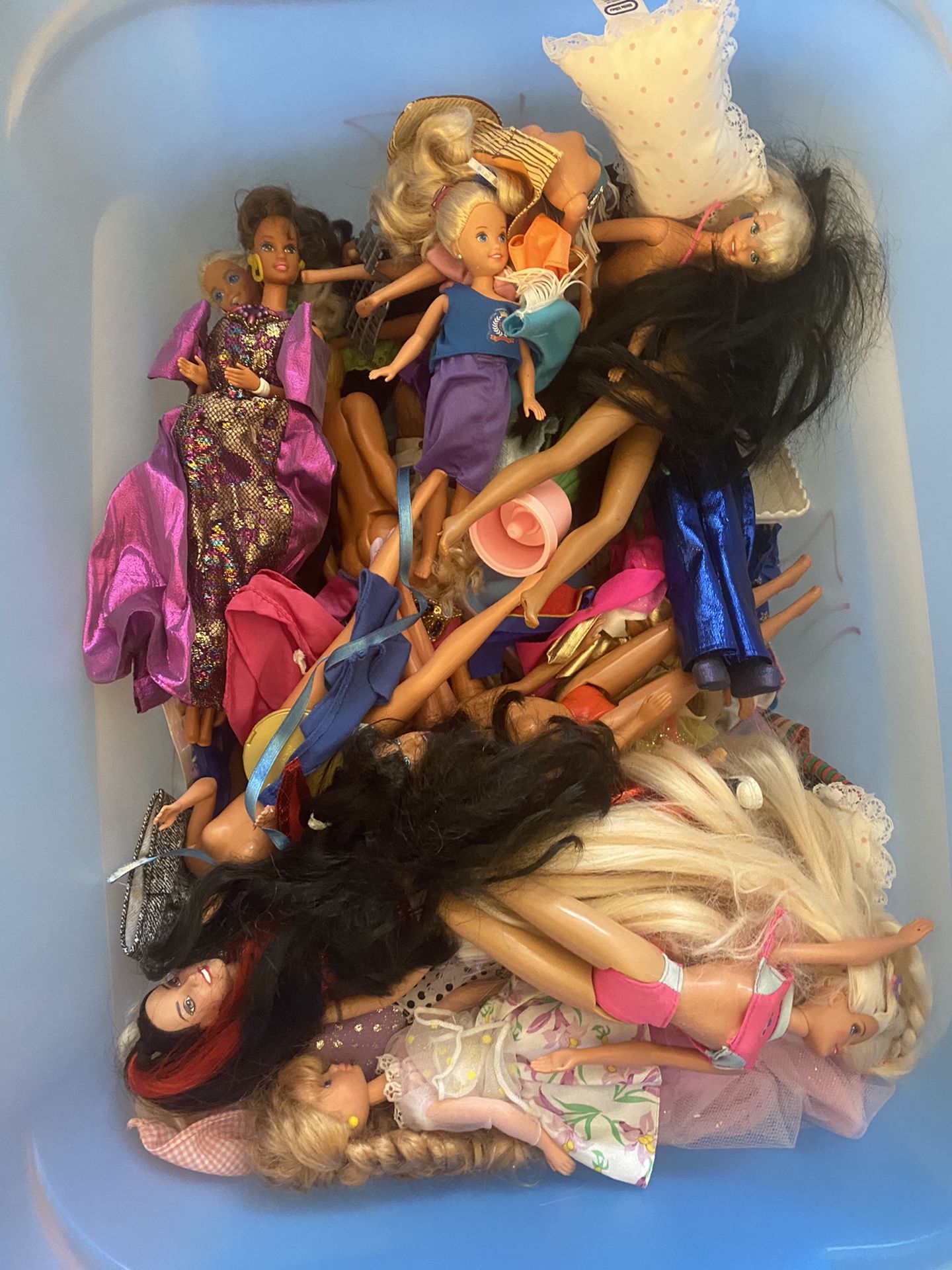 Miscellaneous barbies, Barbie clothes, and a Barbie playhouse