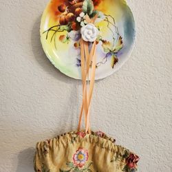 Vintage-style floral fabric handbag/pouch exudes a classic charm with its round shape and tie closure