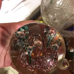 Vintage clear glass paperweight with red and green flowers inside
