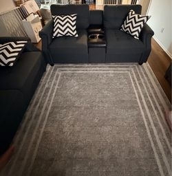 Gray 2 seat couch with cup holders and built in charging outlets