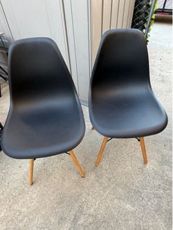 Pair of Black Eames-Style Molded Plastic Dining Chairs with Wood Legs – Good Condition