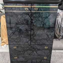 Cabinet/Chest Featuring A Modern Style With Black Lacquer, Marble Finish Look And Gold Accents.