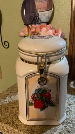 COOKIE JAR - FLOWERS ARE SHOEN ON ALL SIDES, ABOUT 9” TALL