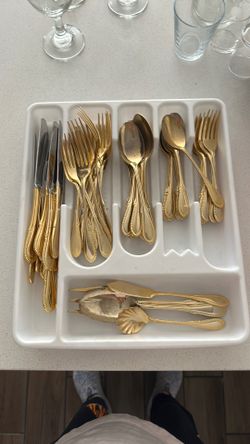 Gold tone flatware set for 12 people