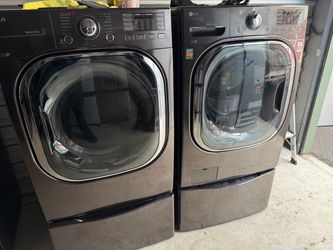 Samsung washer and electric dryer on pedestals