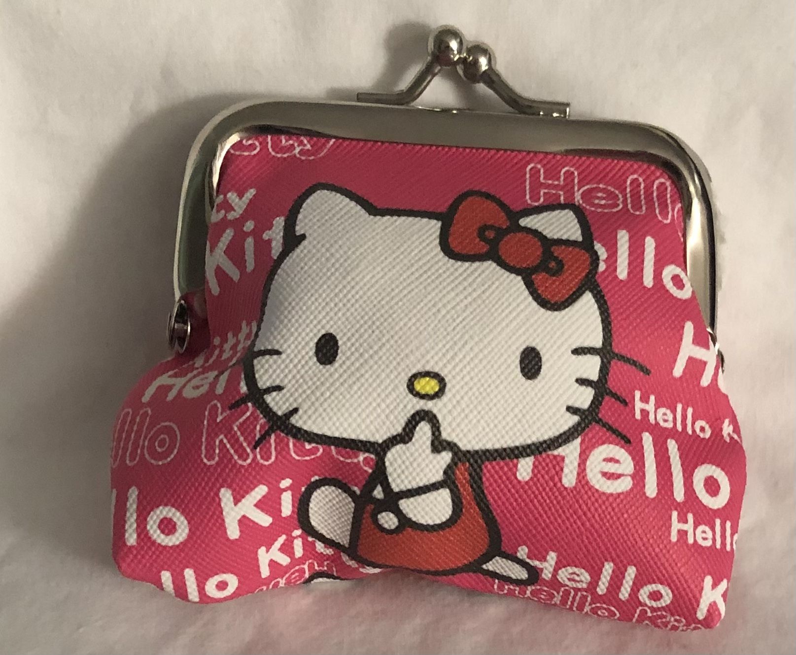 Hello kitty coin purse Hello Kitty graphics kiss lock closures pink.