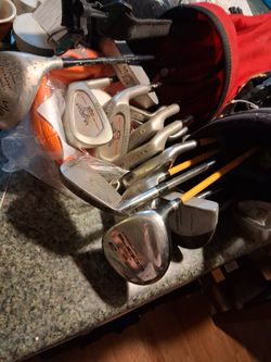 2 sets of golf clubs with bags and accessories
