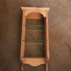 Light Colored Wood Shelf With Three Glass Shelves