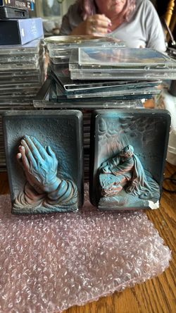 Vintage plaster praying hands and kneeling Jesus