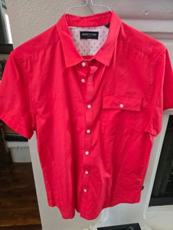 Kenneth Cole Short-Sleeve Sport Shirt features a vibrant red colorway, structured point collar, and a signature patterned interior yoke lining. It is 