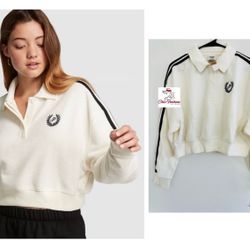 PINK REVERSE FLEECE CROPPED POLO SWEATSHIRT Medium  The Takeaway: Puts some prep in your step Sporty stripes and a cropped silhouette kick this classi