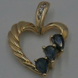 10KT YELLOW GOLD HEART PENDANT W 3 SMALL DIAMONDS; 3 SYNTHETIC SAPPHIRES 2.4 GRAMS. PRE OWNED. MINT CONDITION. 849283-3.