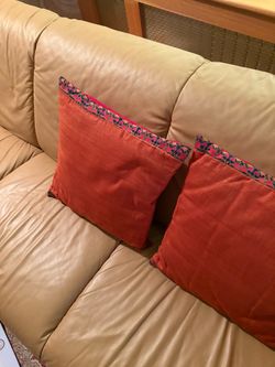 Burnt orange silk cushions with a hand crafted trim Set of 2