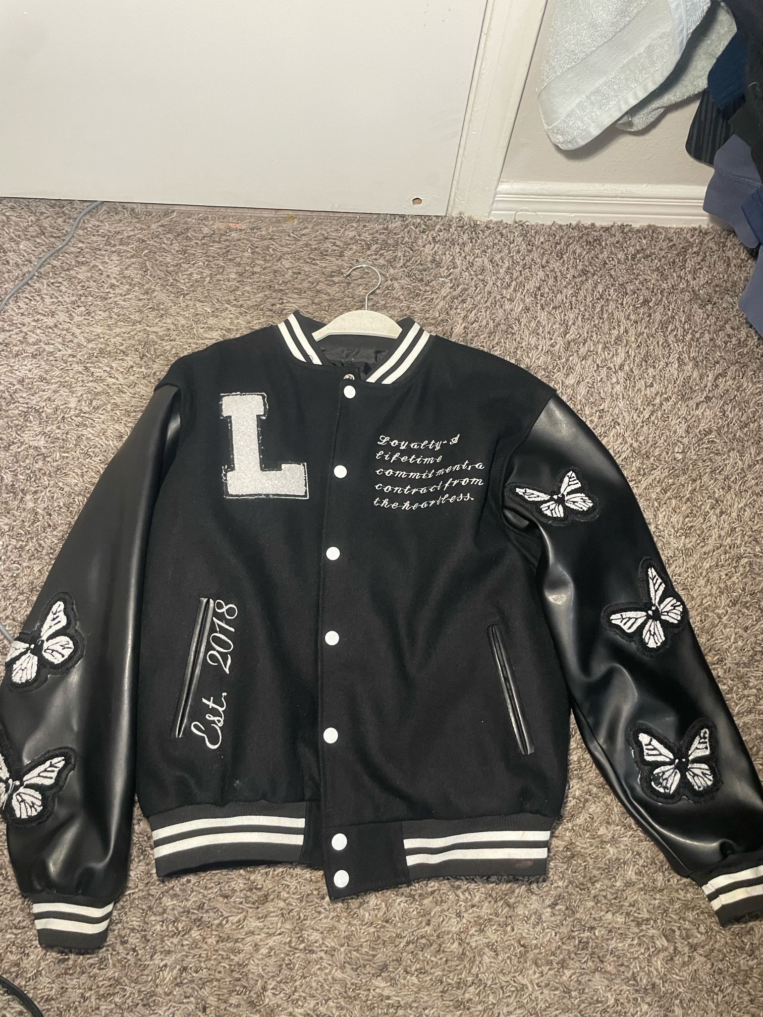 black and white letter L varsity jacket
