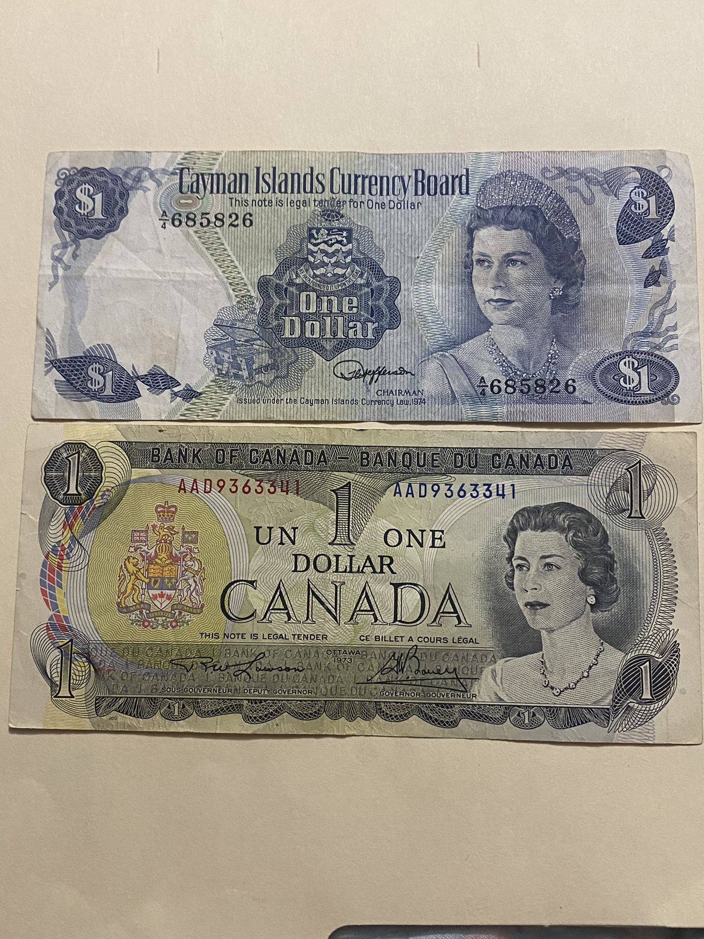 Two collectible banknotes from Canada featuring Queen Elizabeth, one from 1973 and the other from 1974, are in good condition. I am asking $30