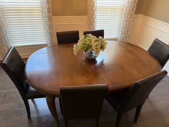 Cherry dining room table with 10 chairs.