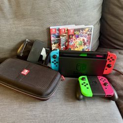 Nintendo Switch with charger stand, case, controllers, & 3 games