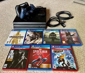 PS4 PRO w/ 7 GAMES & 2 CONTROLLERS, CHARGING DOCK
