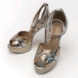 The ShoeDazzle Women's Gold Silver Stiletto Heels are a glamorous pair of pumps designed for various occasions. With a pointed toe and ultra high 5 in