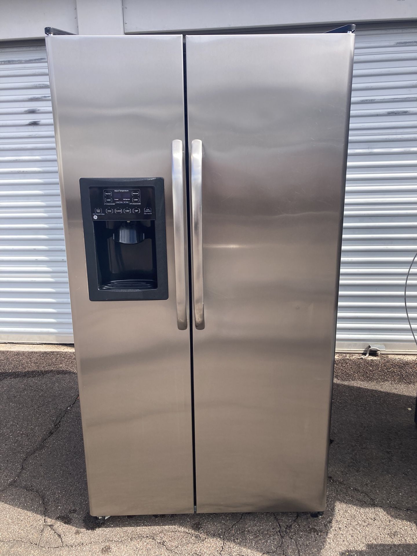 GE side by side stainless steel refrigerator in good condition, clean and nice, one month warranty, delivery available W36-D31-H69