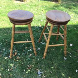 Two solid oak, swivel barstools