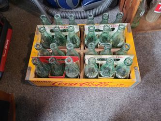 Here is the case of antique Coke bottles plus the case plus the cartons they fit in from the 50s and 60s with different states on them one is Chambers