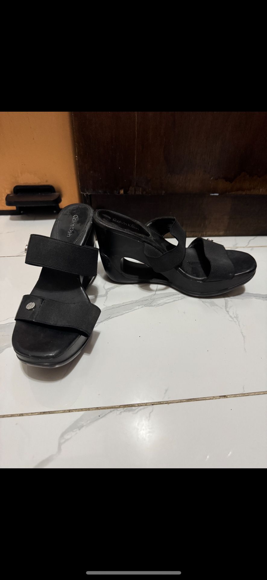 Item: Calvin Klein Platform Sandals Color: Black Features: These sleek Calvin Klein platform sandals feature an open-toe design, stretchy straps for