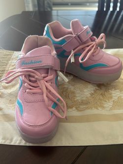 These pink and blue Fashion brand sneakers feature wheels and glowing LED lights in the soles.