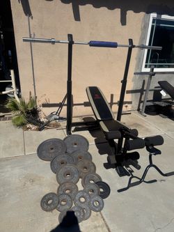 Bench press/ squat rack with 7ft 45lbs bar and 265lbs of Olympic weights