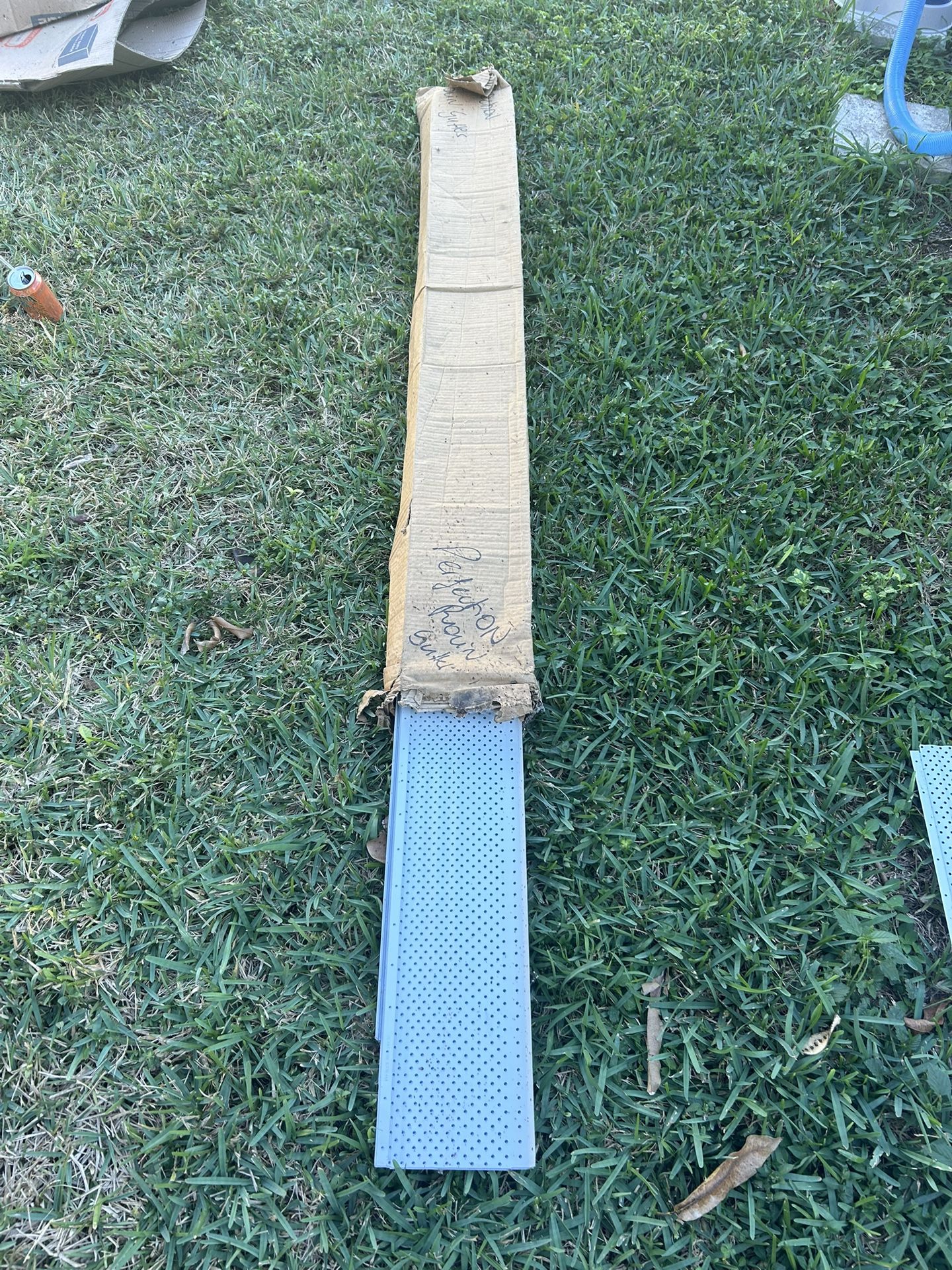 Perforated aluminum soffit vent panels.