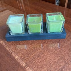 Three shades of green new candles with candlestick holders clear glass in a Woodrow
