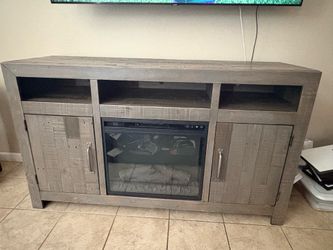Great condition tv stand with fire place.