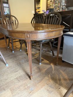 Vintage extendable wooden dining table with 6 chairs for $800