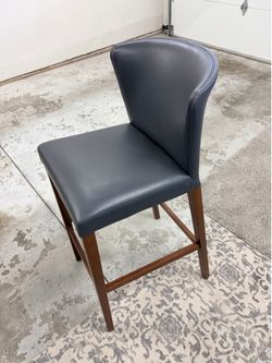 Three gray leather barstools