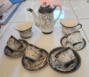 Vintage Japanese Moriage Dragonware Porcelain Tea Set. Total 11 individual pieces: 1 lidded teapot, 2 creamers, 4 teacups, 2.5 Diameter, 2.5" H. 4 sau