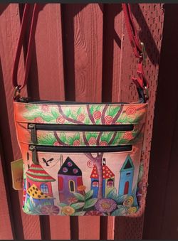Brand new never used Anuschka original hand painted no two are the same handbag. Comes w/care card and dust bag
